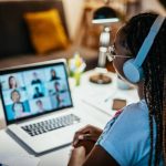 A lady engaging in online learning with other student