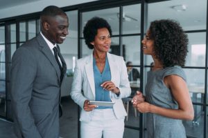 Image of diverse employees working together in an office setting, highlighting the importance of soft skills in a collaborative work environment.